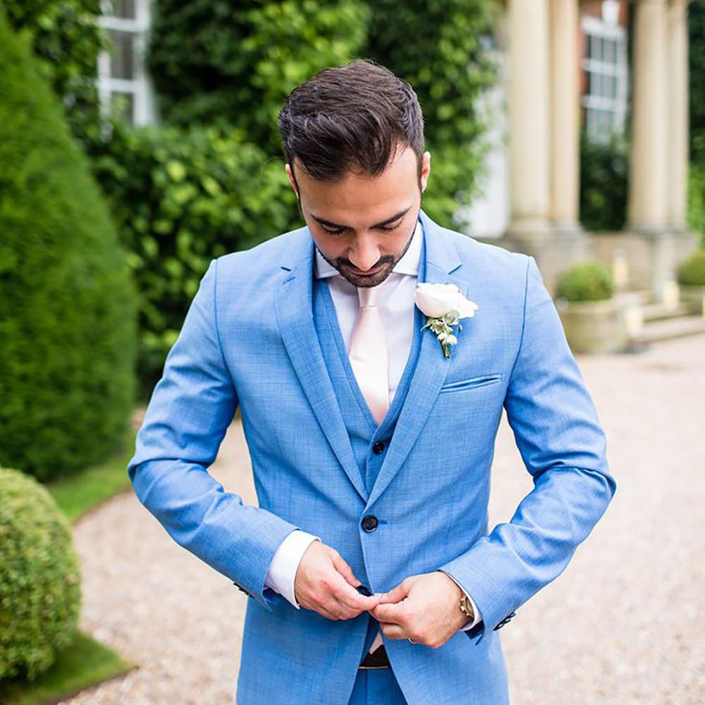 Groom in bright blue wedding suit for classic country house wedding 