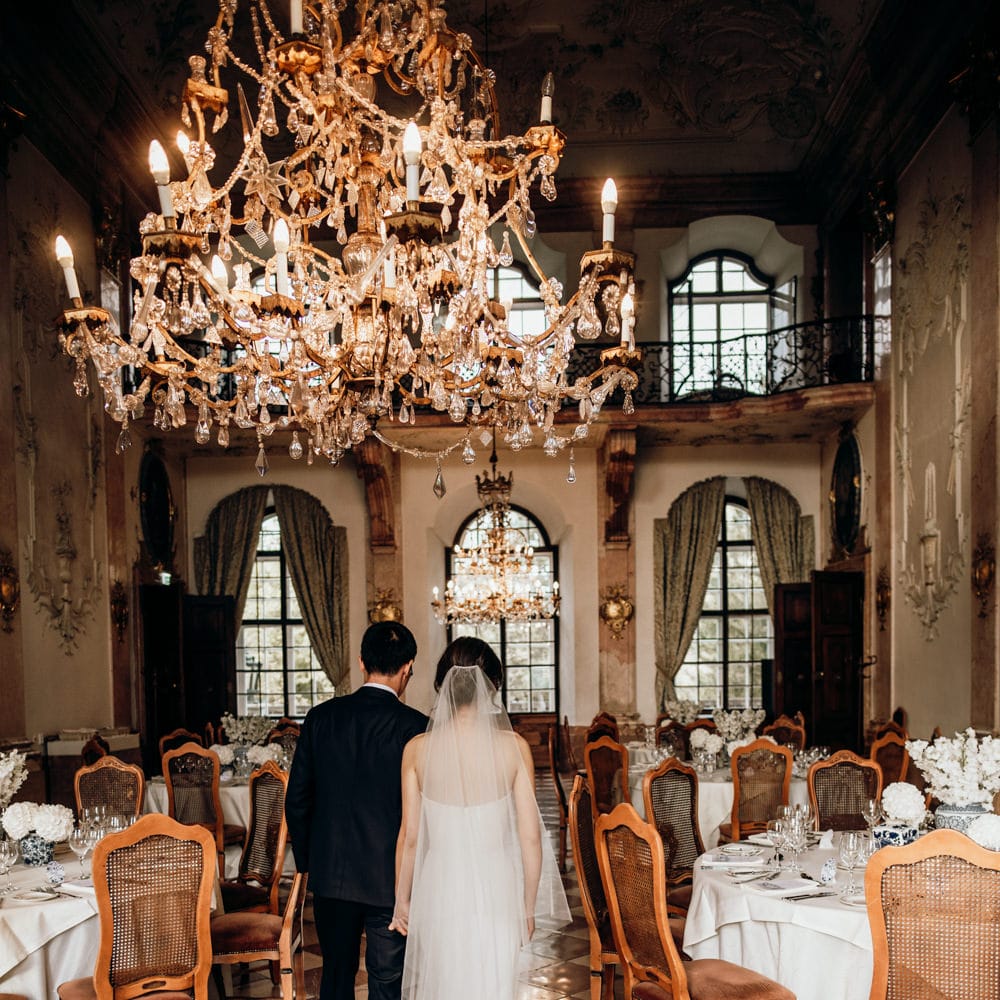 Bride and groom entering their intimate wedding reception at Hotel Schloss Leopoldskron, Salzburg, Austria
