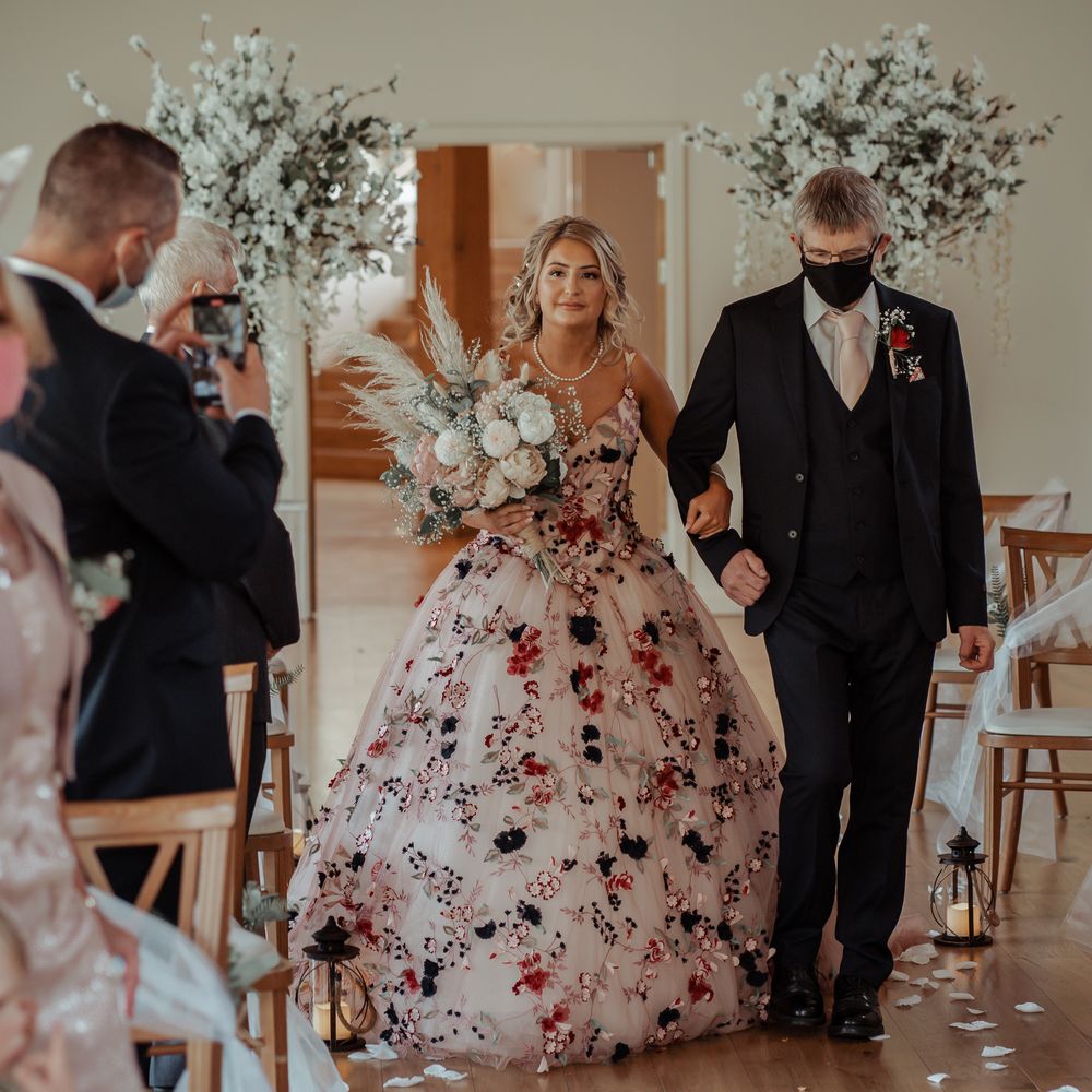 Bride walks down the aisle with father on her wedding day