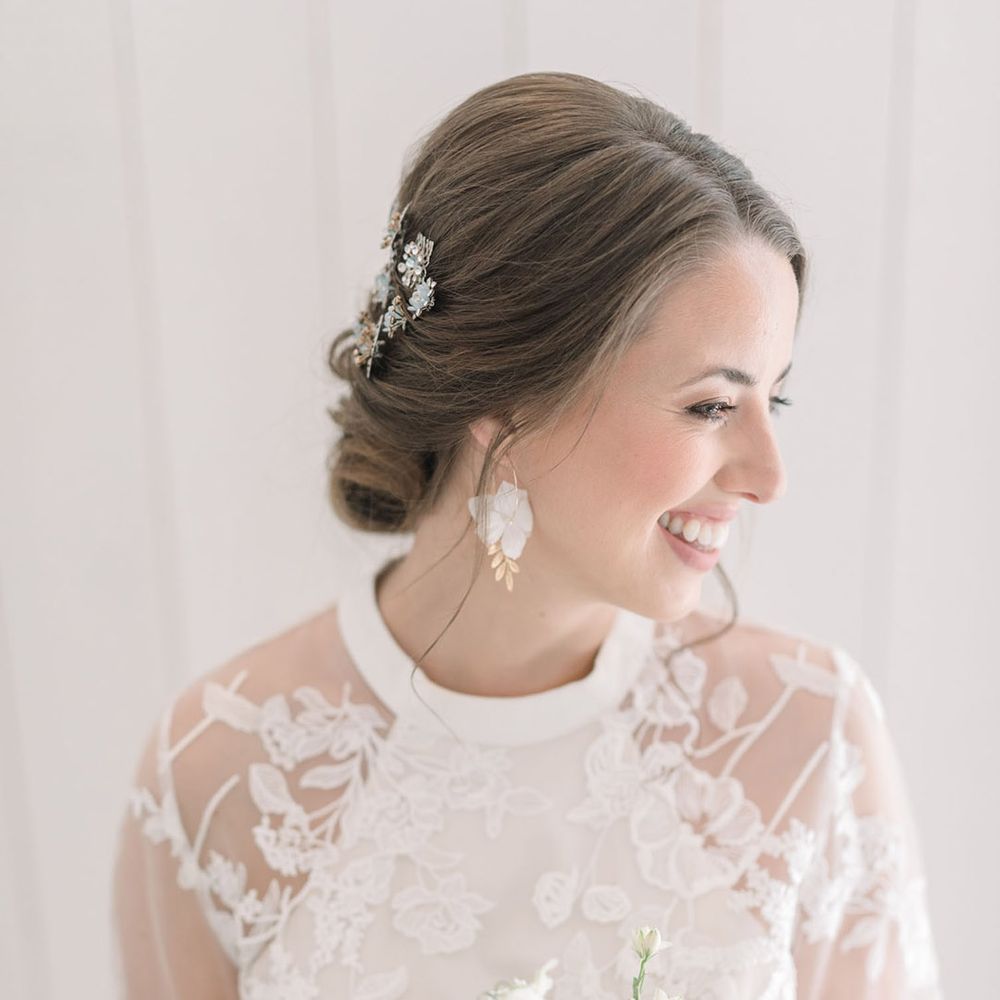 Bride in a lace Phase Eight wedding dress holding a pastel flower wedding bouquet with anemones