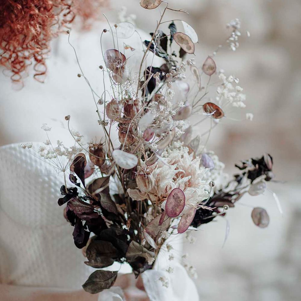 Minimalist wedding bouquet with fragile dried flower stems 