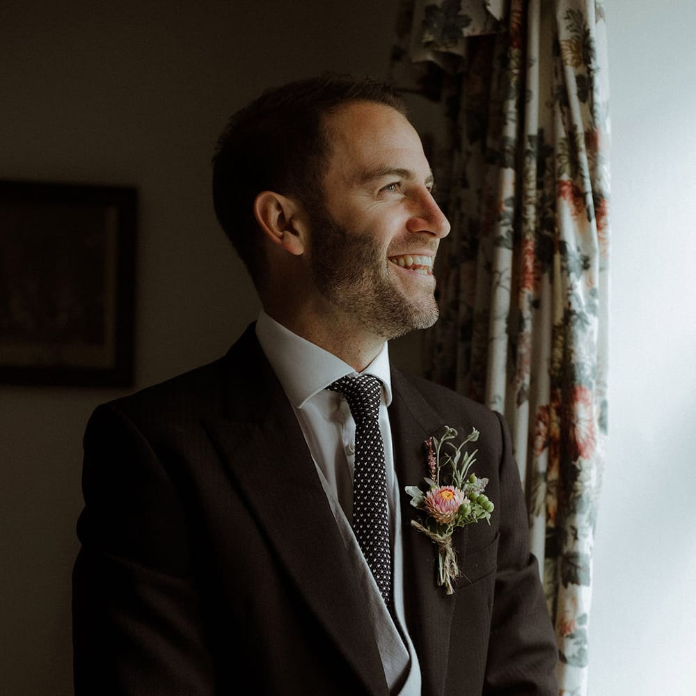 Wedding guest in morning suit with grey waistcoat and spotted tie 