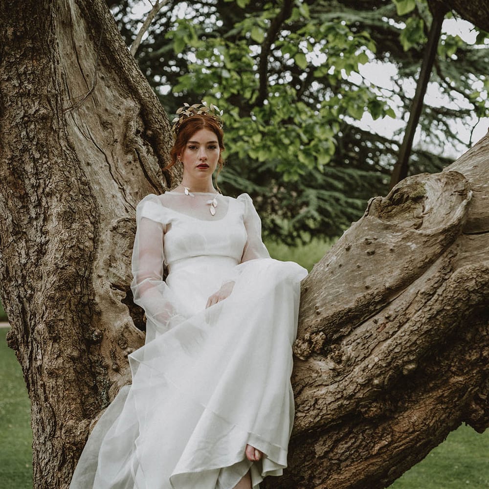 Eco bride in a sustainable fabric wedding dress with two layers and gold leaf jewellery 
