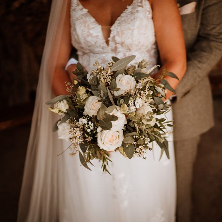 Classic white roses and flowers with greenery for the bridal bouquet 
