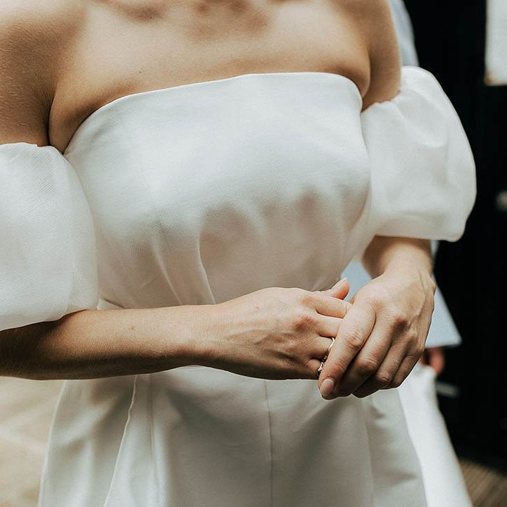 Bride wears Jesus Peiro wedding dress complete with detachable puffed sleeves 