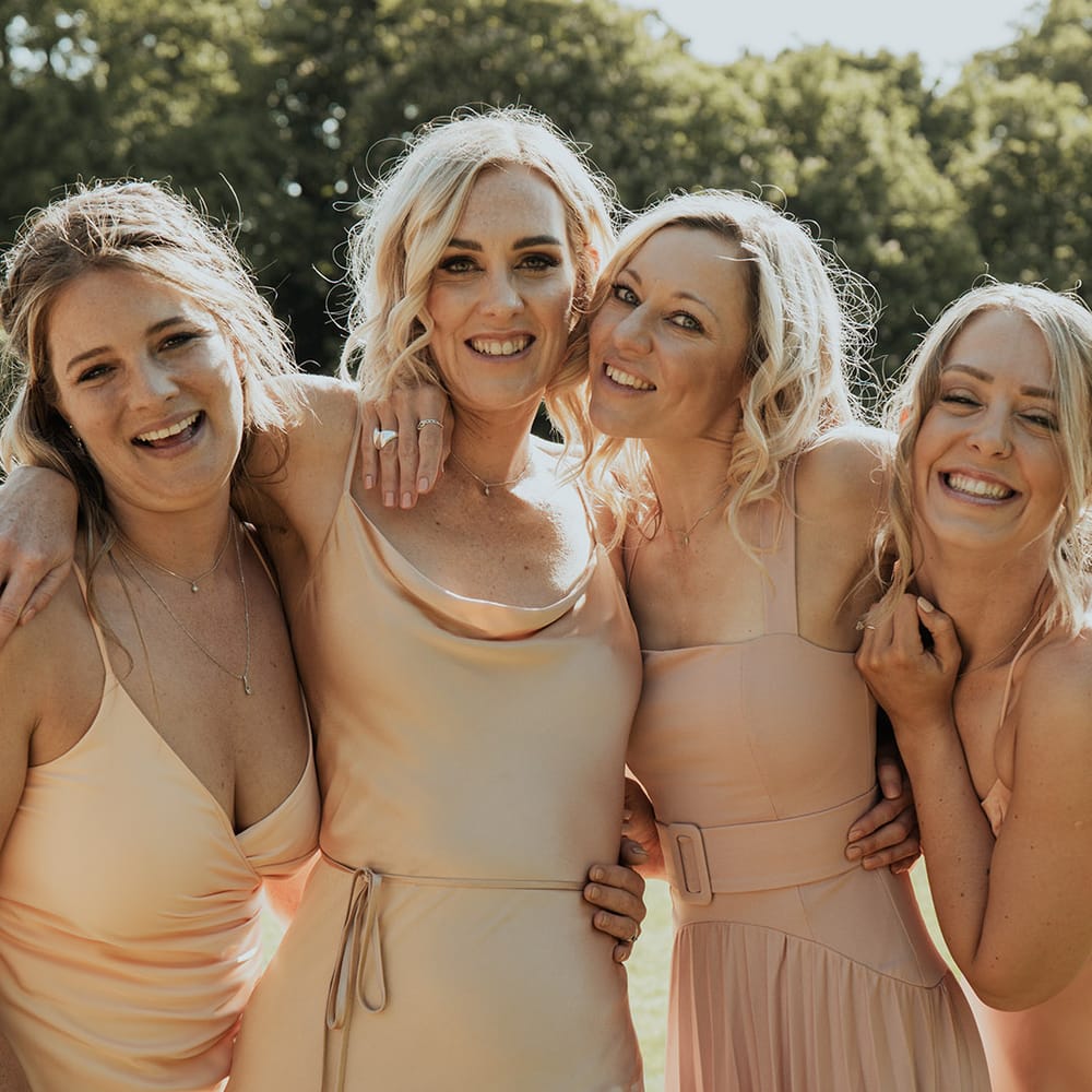 Bridesmaids in mismatched style neutral bridesmaid dresses for the wedding party 