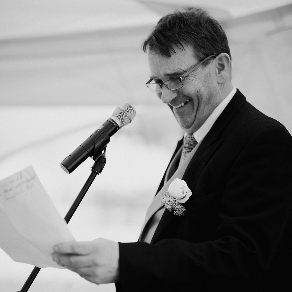 Father of the bride reading out wedding speech 