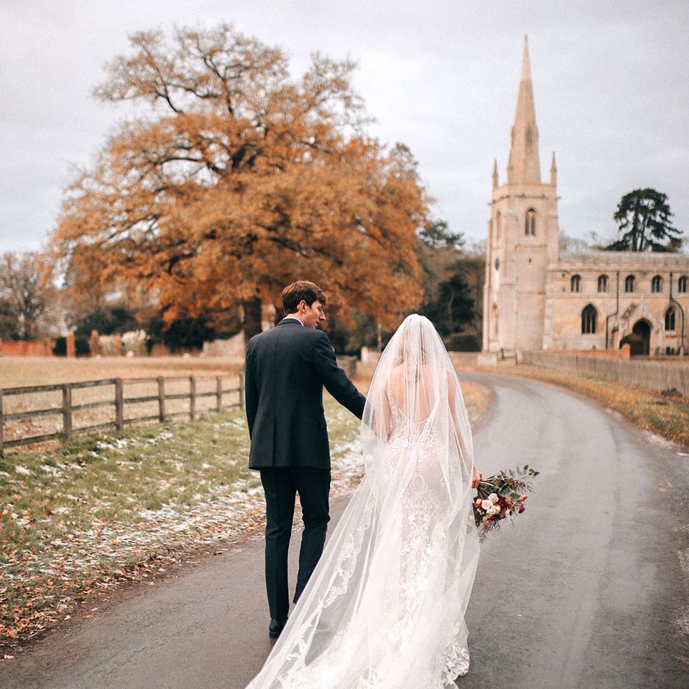 Festive winter Christmas wedding with the bride wearing a lace veil and wedding dress 