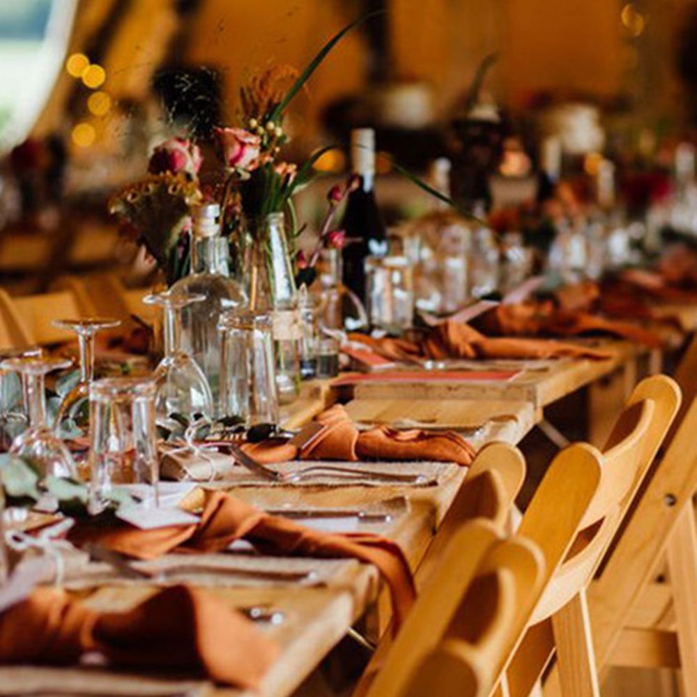 Warm toned orange wedding tablescape with orange napkins at the Lake District wedding venue 