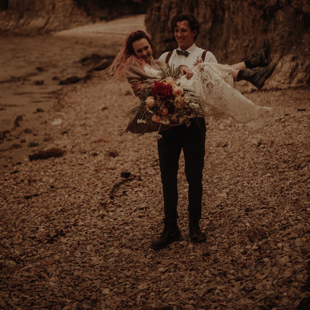 Groom picking his bride up at Lake District elopement wedding