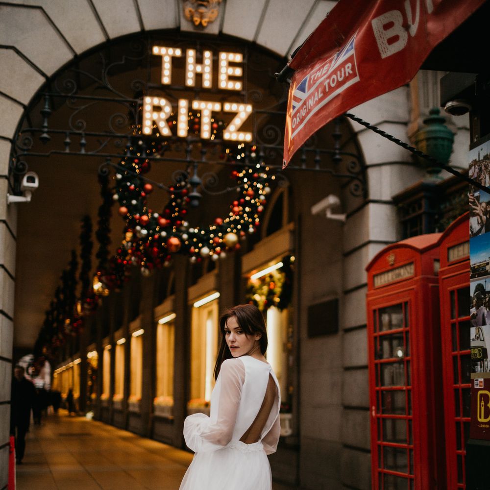 Bride in mini wedding dress with midi sheer layer and backless details