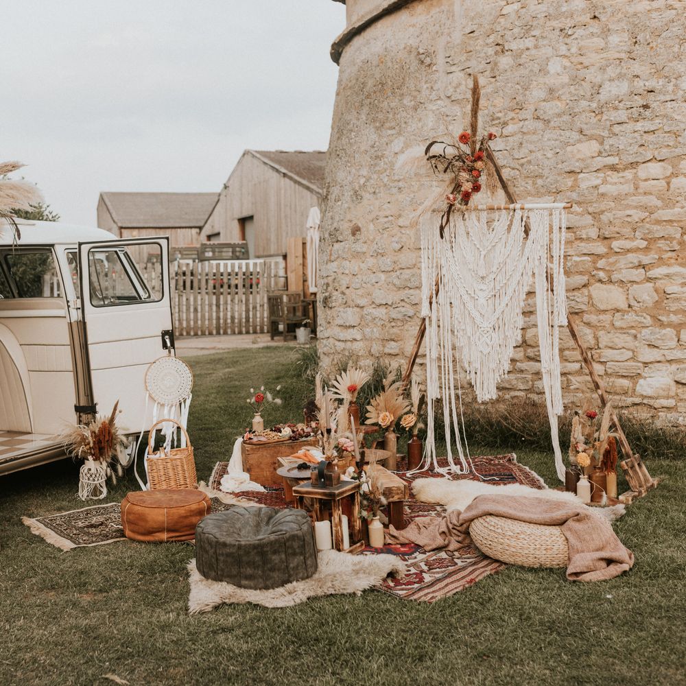 Outdoor picnic in boho inspiration with camper van and grazing plate