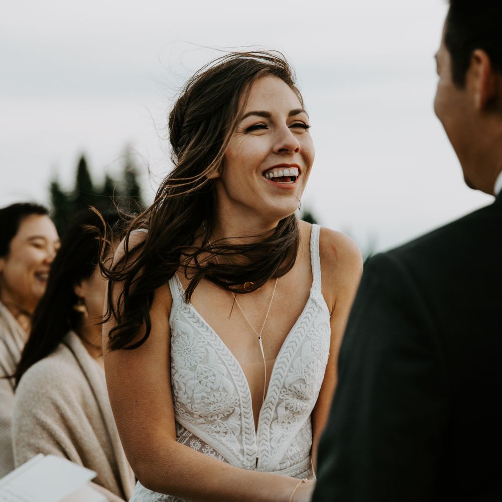 Bride laughs during wedding ceremony