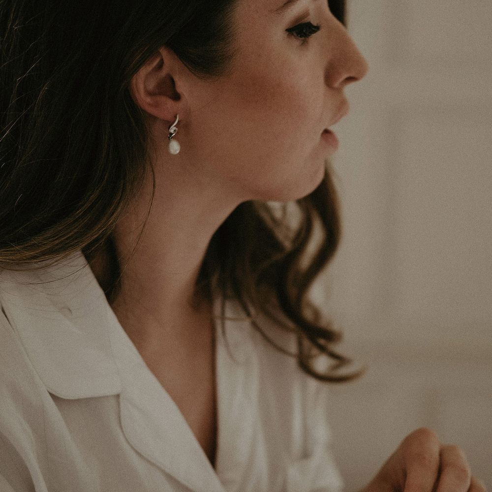 Bride wears her brown hair in loose curls on the day of her wedding