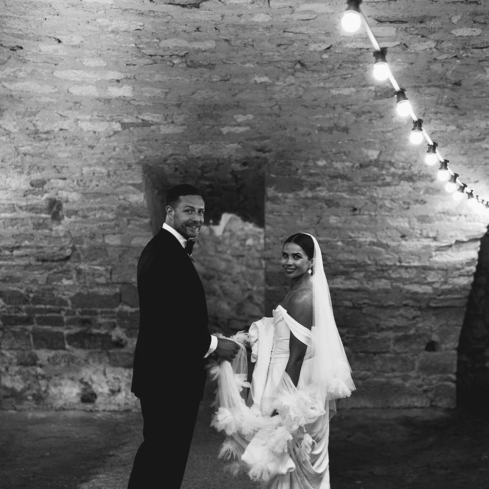 Bride & groom stand with one another in black & white image on their wedding day