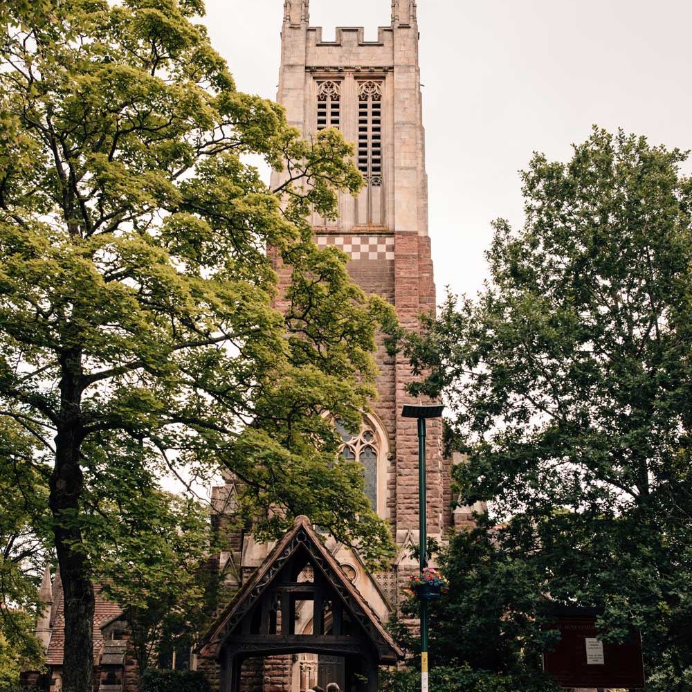 Groom in blue and white vintage wedding car gets out at the church before wedding ceremony