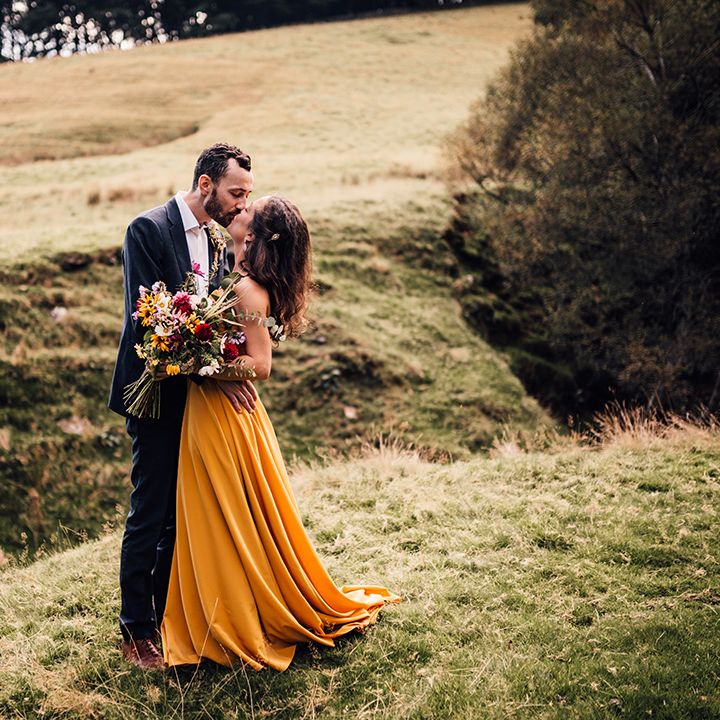 Bride & groom embrace outdoors after ceremony