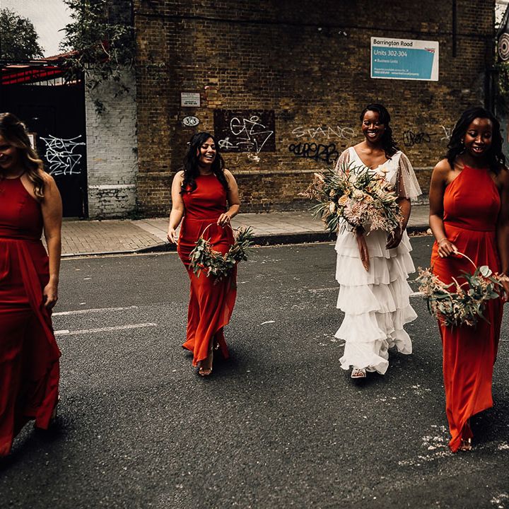 Bridal party in Sienna burnt orange bridesmaid dresses with the bride in Story Of My Dress bespoke bridal separates 