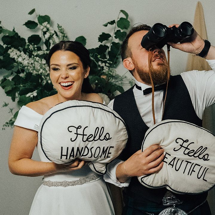 Bride and groom holding hello handsome and hello beautiful cushions, Photo Booth props 