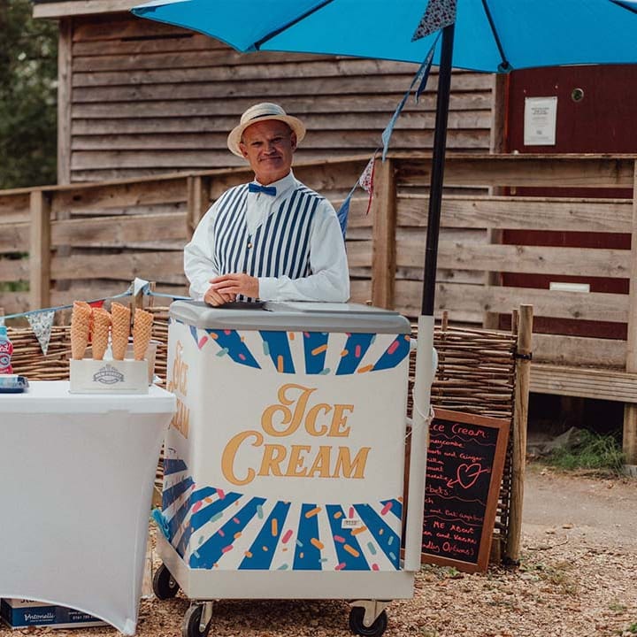 Ice cream stand for wedding guests with flavoured sauces and waffle cones