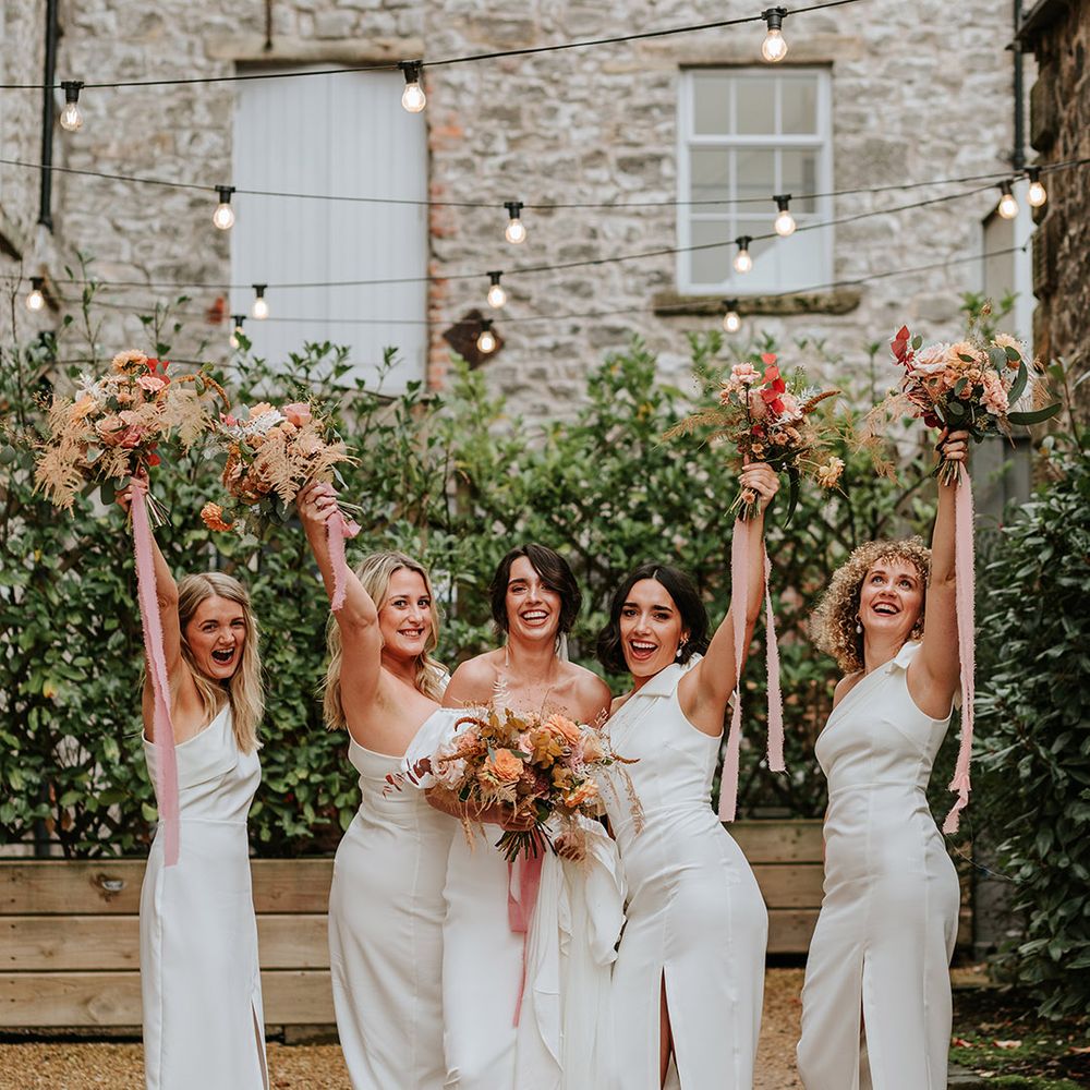 White one shoulder bridesmaid dresses for four rbdiesmaids with bride in Alexandra Grecco wedding dress