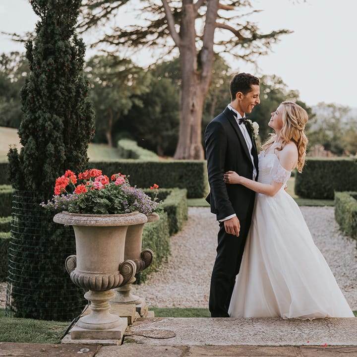 Bride and groom kiss at their country house wedding 