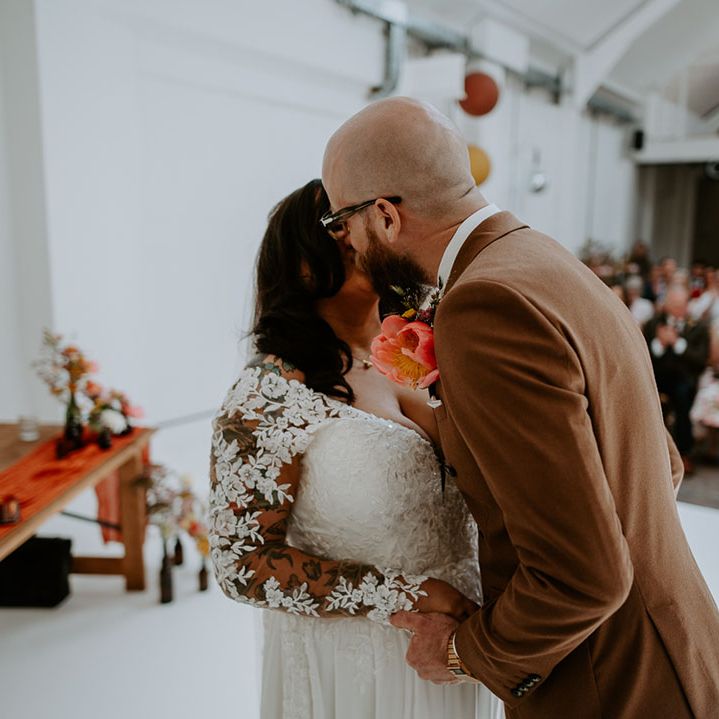 Bride wears floral lace embellished sheer sleeve wedding dress 