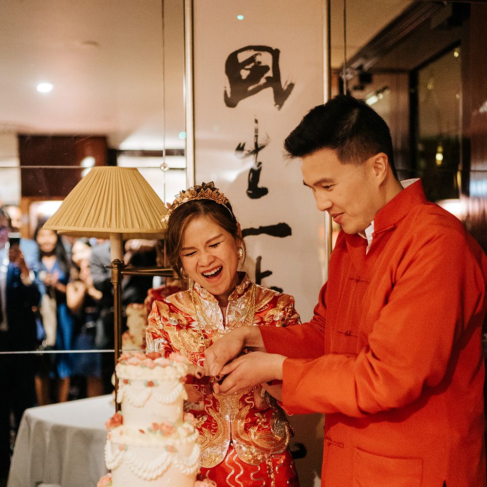 Bride & groom cut wedding cake at The Dorchester during wedding reception 
