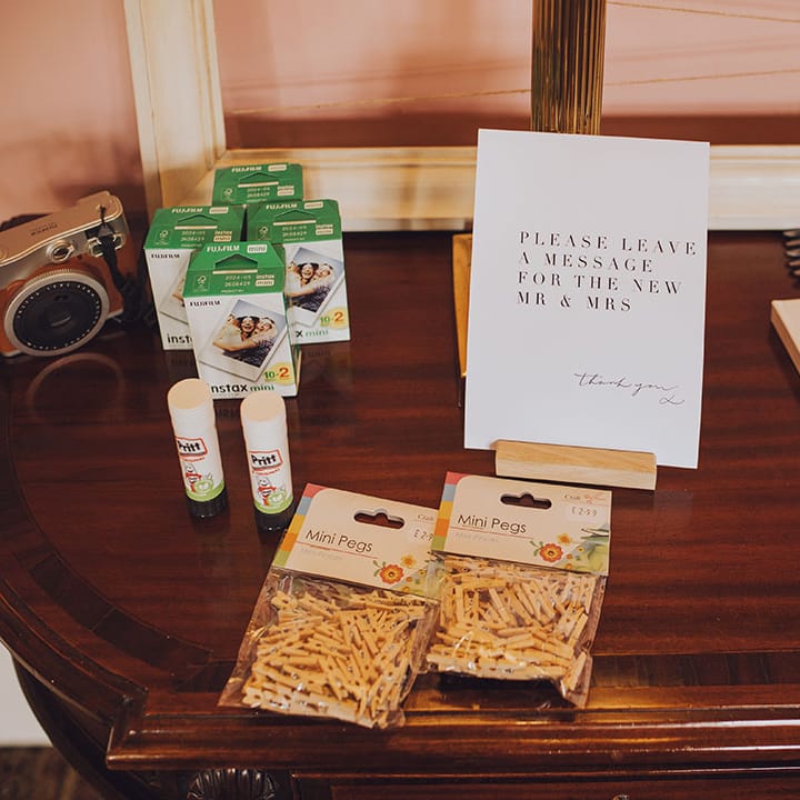 Table set up for Guest Book complete with polaroid camera for personal photos