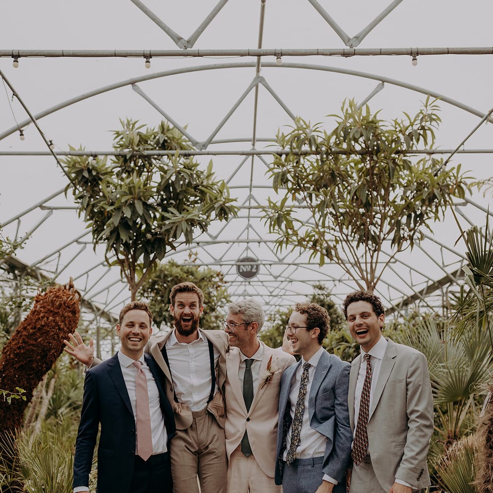 Groomsmen pose for photo in tonal neutral suits