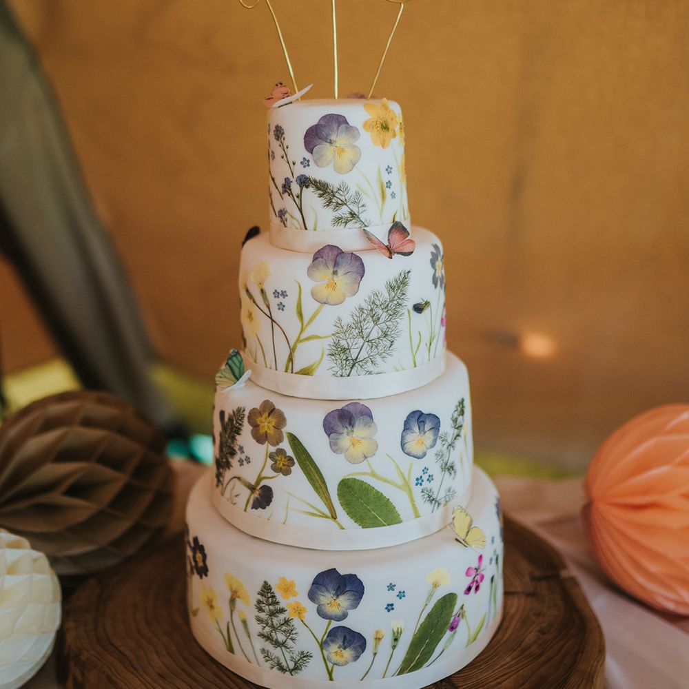 Four tier wedding cake complete with flower pressed decor and butterflies 