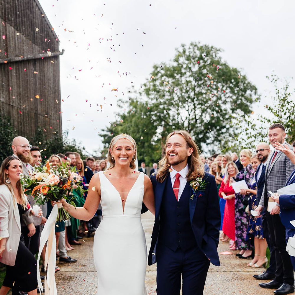 Fun confetti exit for the bride and groom on their wedding day in the South East in Surrey 