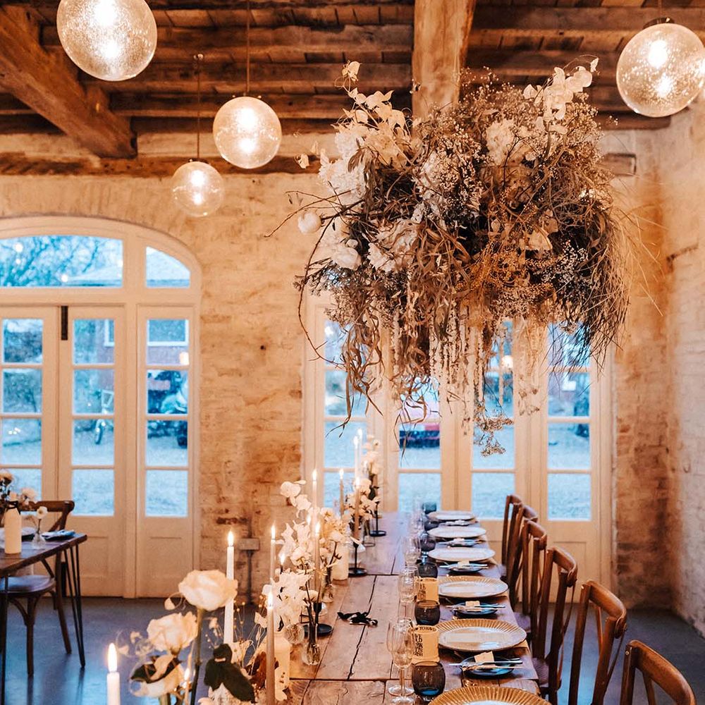 Iscoyd Park wedding venue with romantic warm lighting and a neutral hanging wedding flower arrangement for a winter wedding 