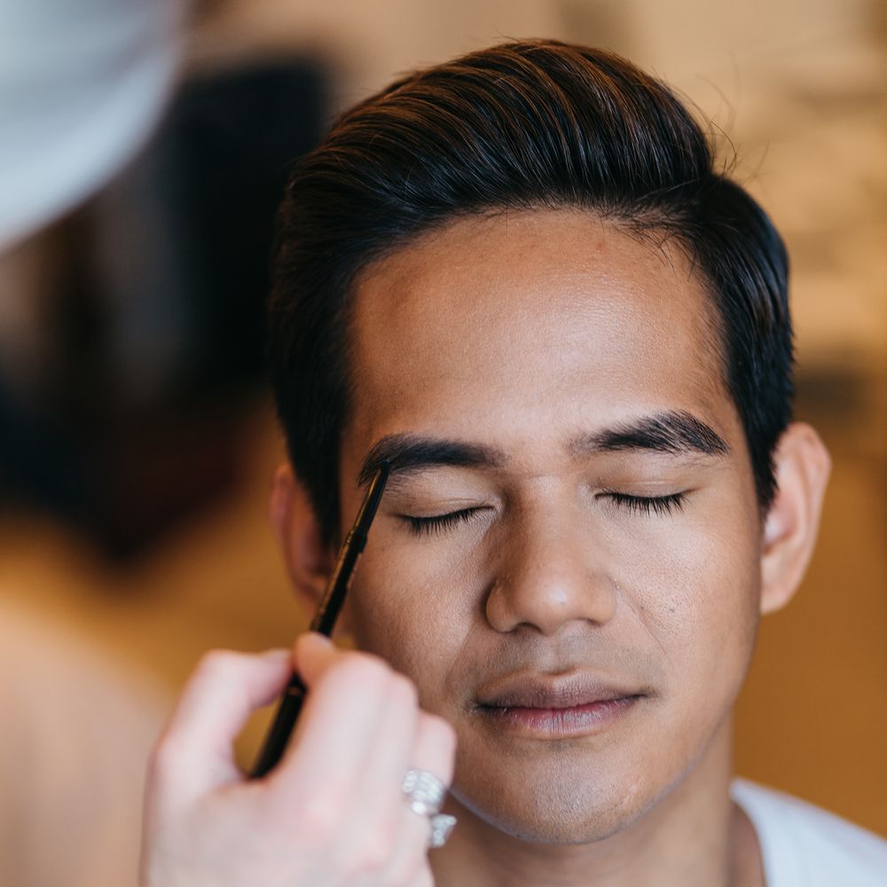 Groom has his makeup done on the morning of his wedding