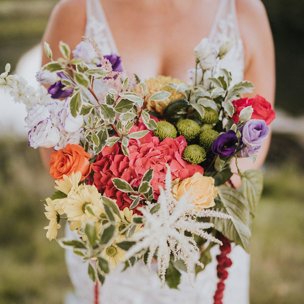 Brightly coloured wedding bouquet with hydrangea, roses, daises and foliage