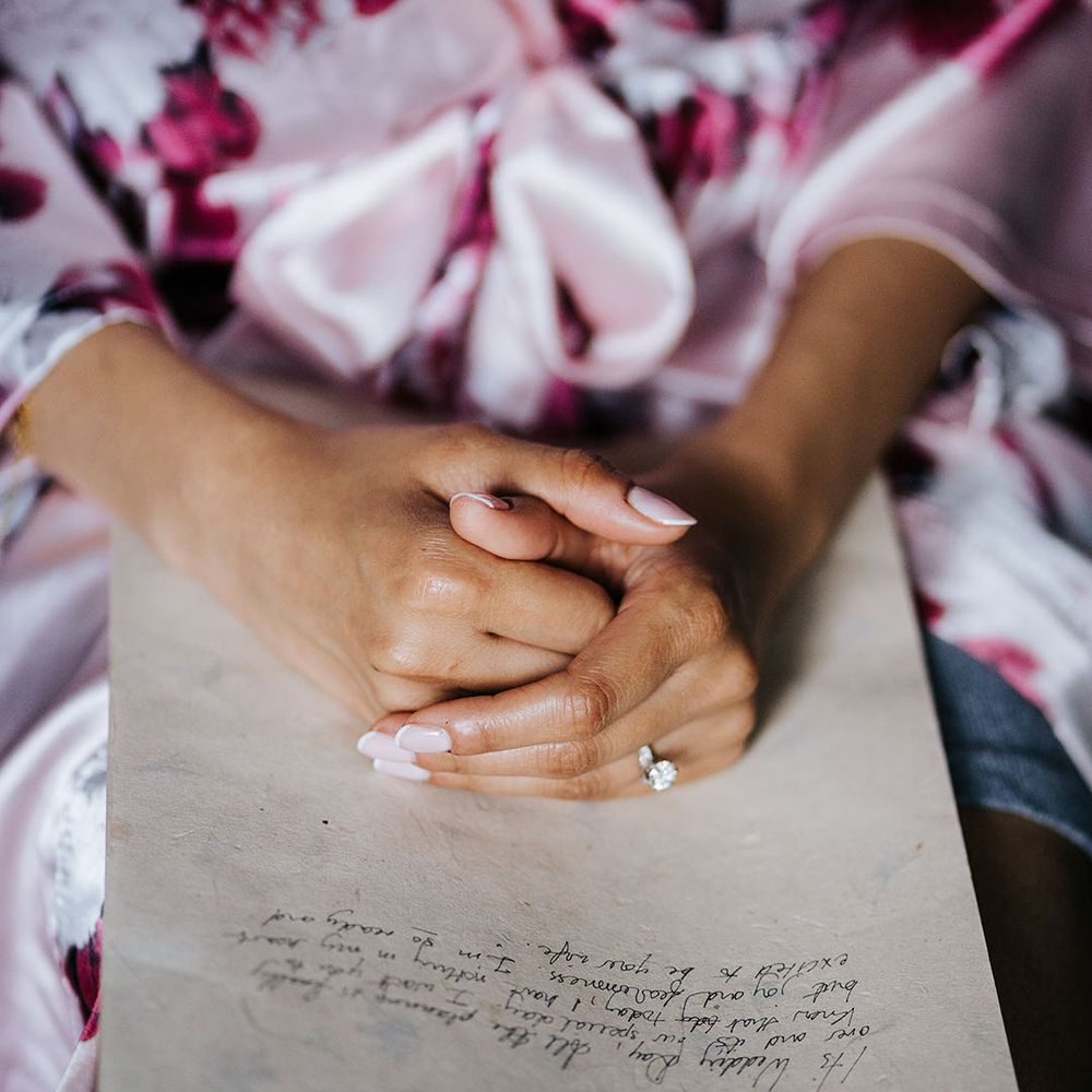 Bride wears french manicured nails on the day of her wedding 