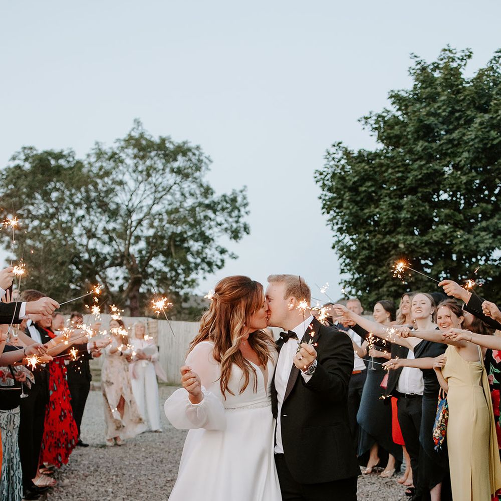 Bride & groom during sparkler exit outdoors at Botley Hill Barn
