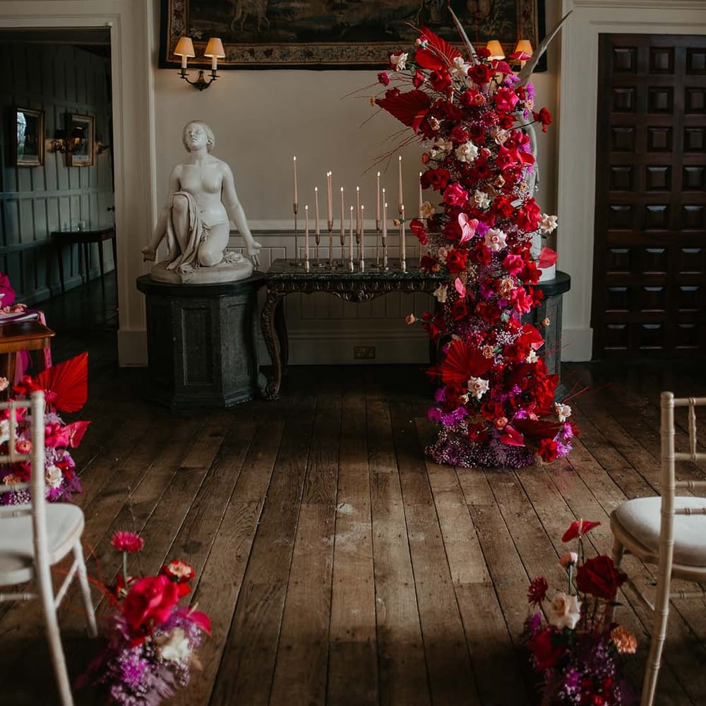 Large floral standing decoration with Hot pink, bright pink and magenta bridal bouquet with dahlias, orchids, roses, anthuriums and dried flowers 