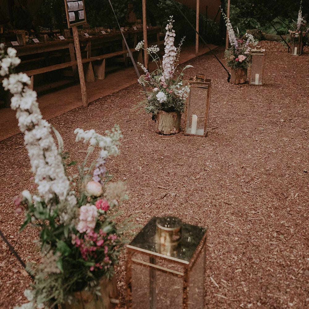 Lila's Wood wedding venue with marquee and long wooden benches for boho outdoor wedding 
