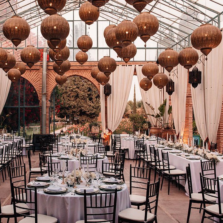 Beldi Country Club wedding breakfast set up with golden lanterns and white wedding drapery 