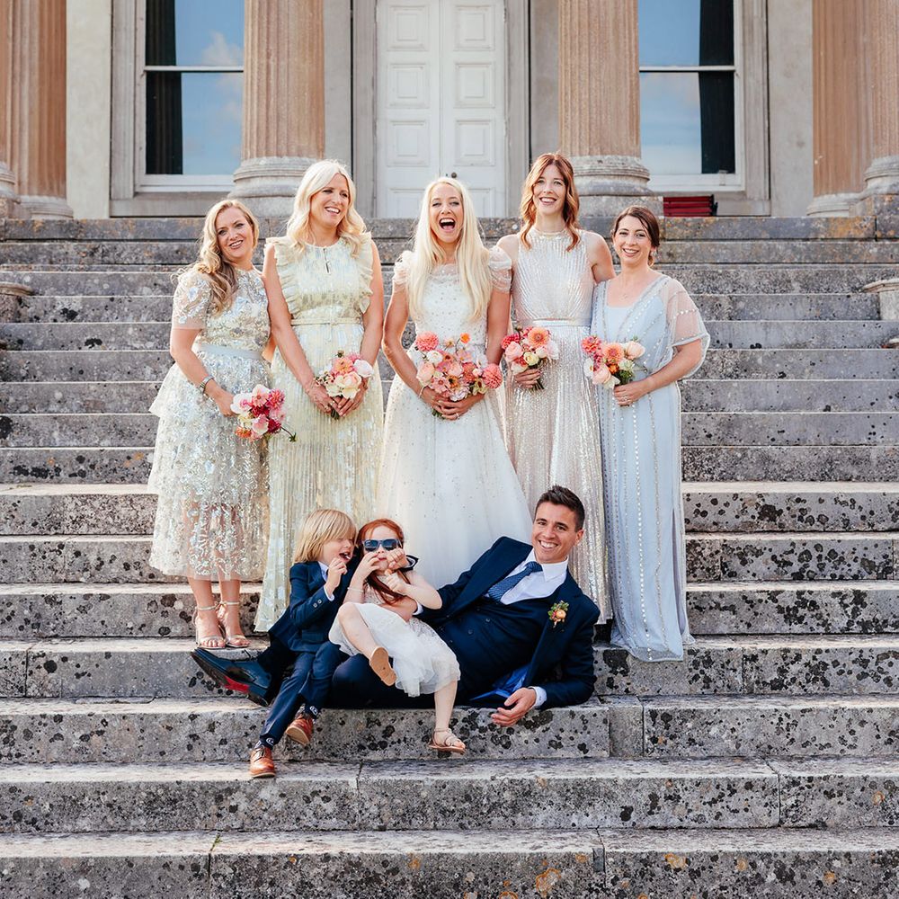 Bridal party wearing metallic bridesmaid dresses with the bride, groom and page boy 