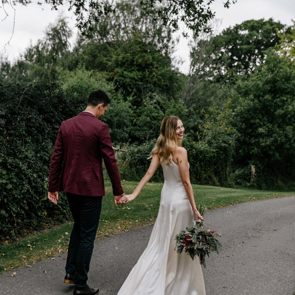 Bride and groom holding hands at 2020 wedding