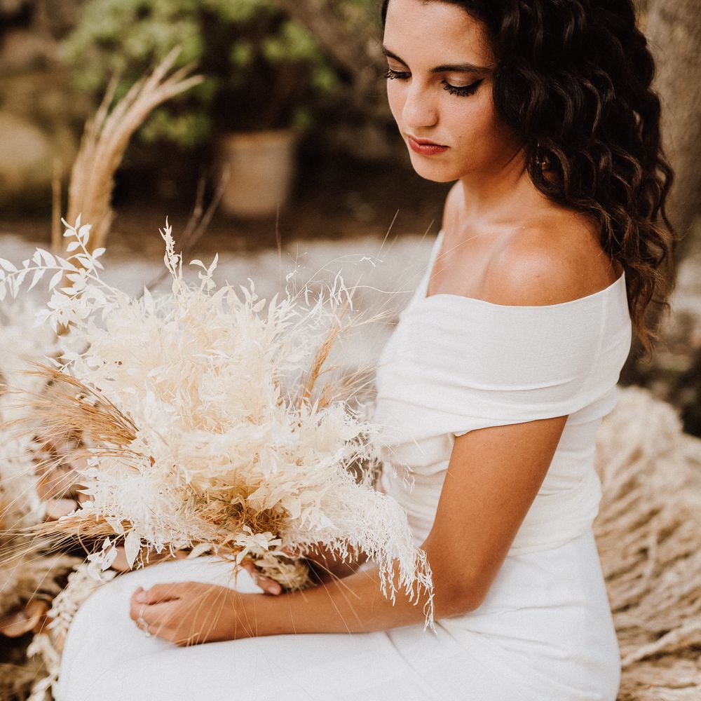 Dark haired bride wearing off the shoulder wedding gown