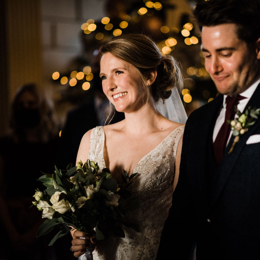 Bride & groom smile together during wedding ceremony