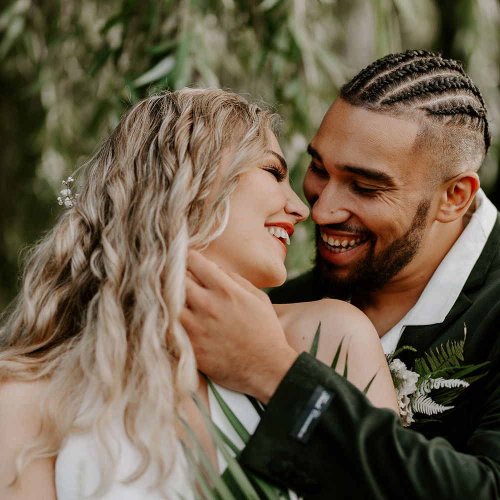 Bride and groom in white and green for tropical wedding theme
