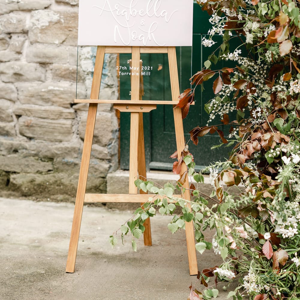 Acrylic wedding sign on a wooden easel at Torr Vale Mill wedding 