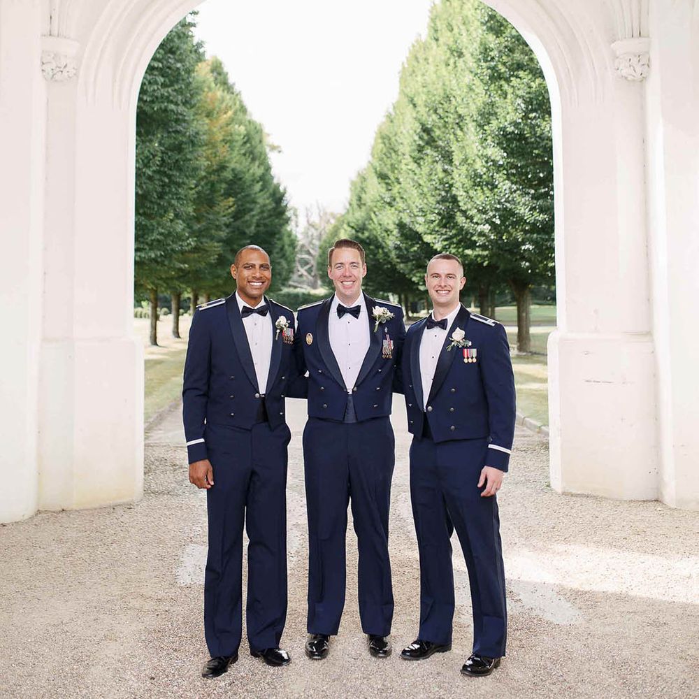 Groom stands with his groomsmen outdoors