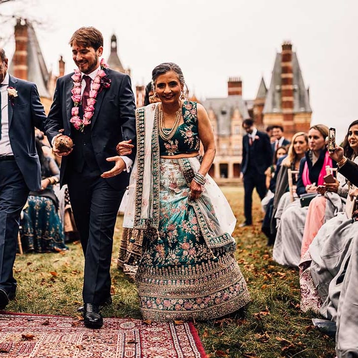 Mother of the bride wears teal sequinned dress at Indian wedding