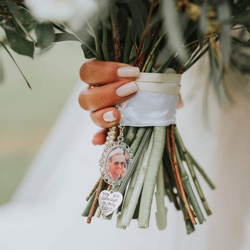 Special photo charm added to the bride's bouquet for a lost loved one