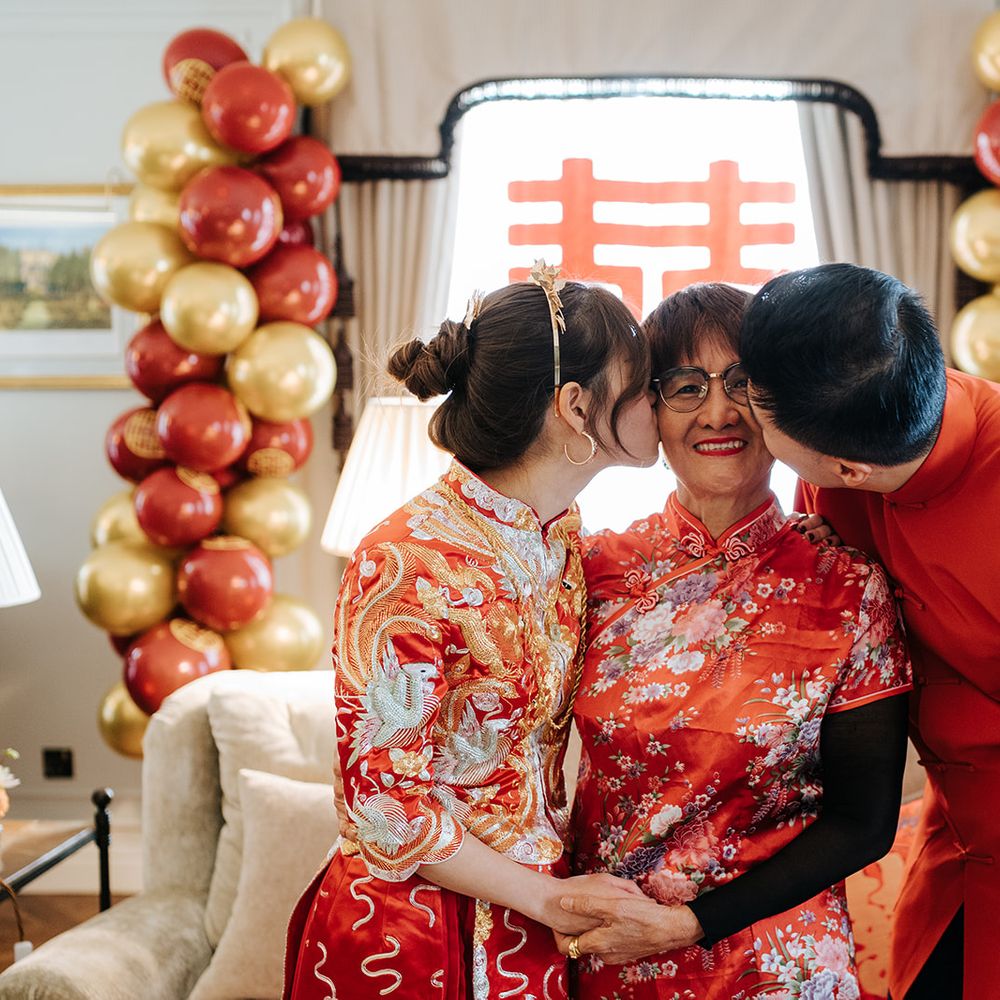 Bride & groom kiss family member at Chinese Tea Ceremony 